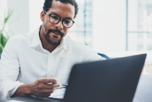 landlord researching condo investment tips on a computer