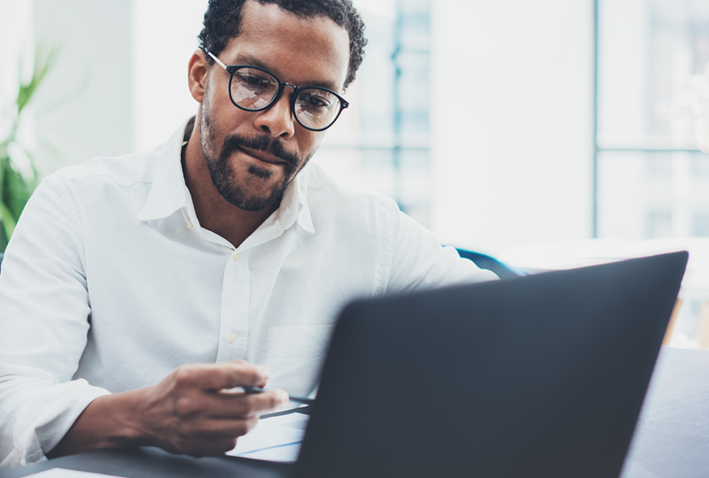 landlord researching condo investment tips on a computer